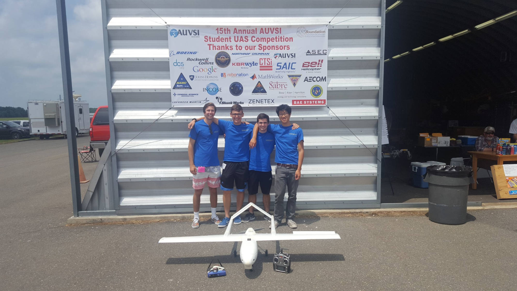 UAS Members in front of fixed-wing aircraft